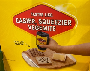 An ad that shows a hand squeezing Vegemite out of a bottle onto bread, with the caption: ‘Tastes like: easier, squeezier Vegemite (tastes like Australia)’